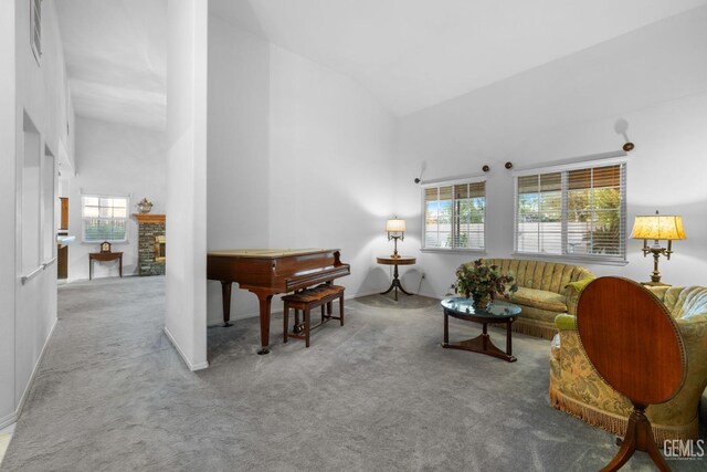 14013 Laverton Ave, Bakersfield, CA 93314 - living room with carpet, high vaulted ceiling, and a brick fireplace