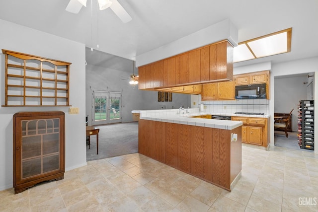 14013 Laverton Ave, Bakersfield, CA 93314 - kitchen with a ceiling fan, black microwave, tile counters, and tasteful backsplash