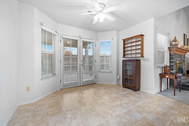 14013 Laverton Ave, Bakersfield, CA 93314 - living area featuring a ceiling fan, baseboards, a fireplace, and stone finish flooring
