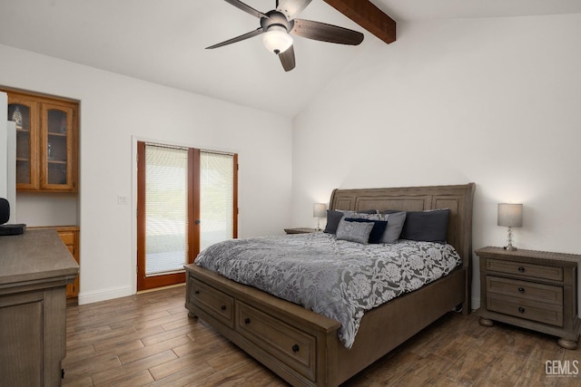 bedroom featuring dark wood-type flooring, ceiling fan, access to exterior, and vaulted ceiling with beams