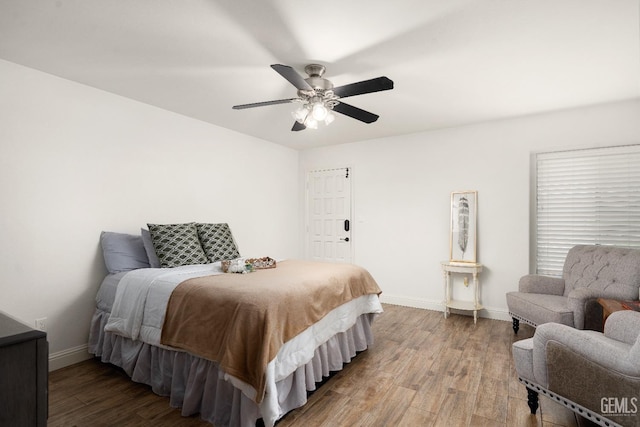 bedroom with wood-type flooring and ceiling fan