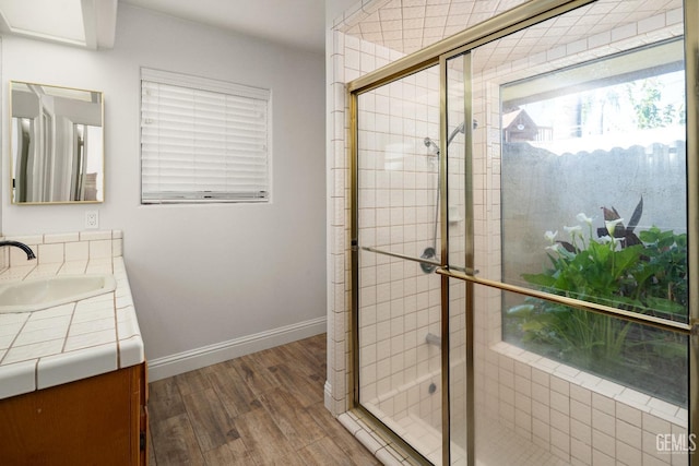 bathroom featuring an enclosed shower, hardwood / wood-style floors, and vanity