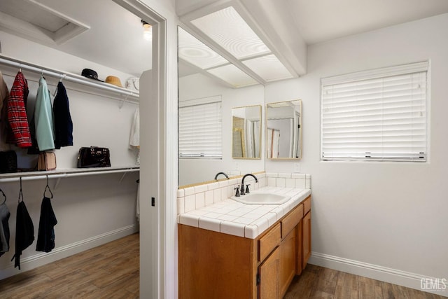 bathroom featuring hardwood / wood-style flooring and vanity