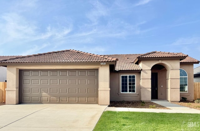 mediterranean / spanish home featuring a garage