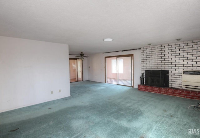 unfurnished living room featuring a textured ceiling, carpet floors, ceiling fan, a brick fireplace, and heating unit