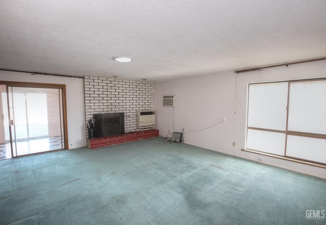 unfurnished living room featuring heating unit, carpet, a brick fireplace, and a textured ceiling