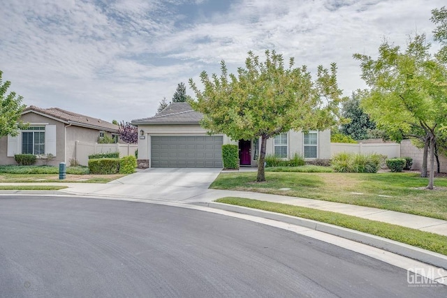 view of front of property featuring a front yard and a garage