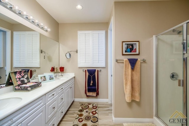 bathroom with vanity, hardwood / wood-style flooring, and an enclosed shower