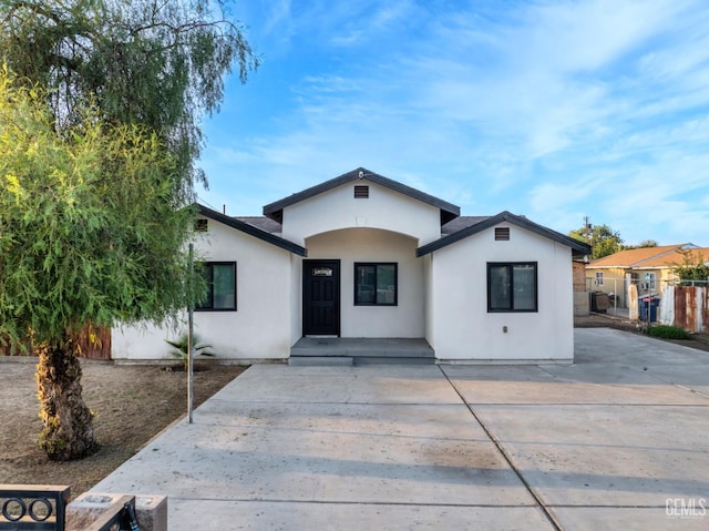 view of front of property featuring fence and stucco siding