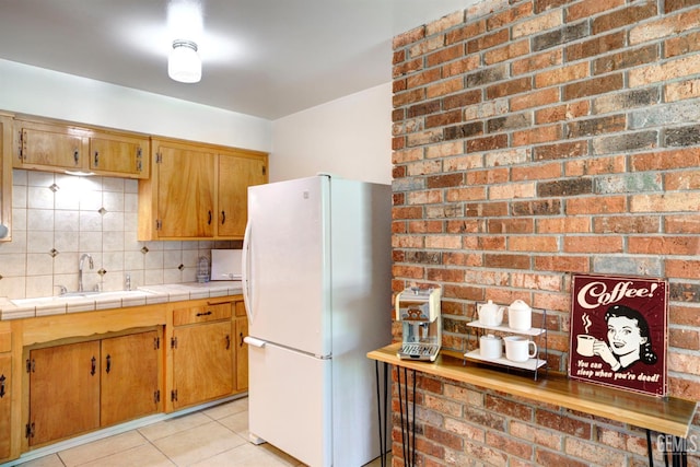 3504 Planz Rd, Bakersfield, CA 93309 - kitchen with freestanding refrigerator, light tile patterned floors, tasteful backsplash, tile counters, and brown cabinets