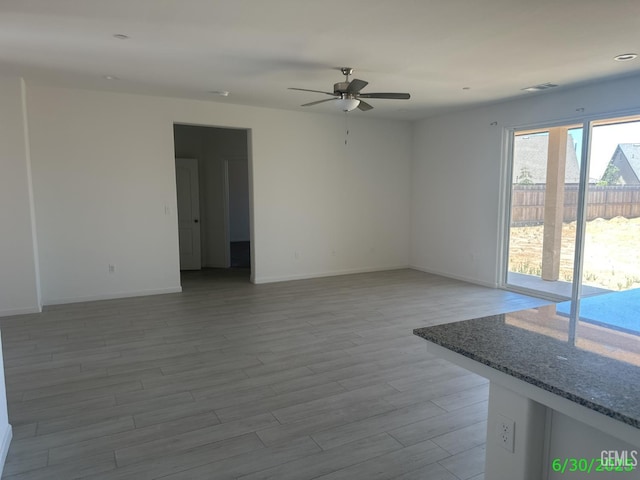 716 Montejo Ct, Delano, CA 93215 - empty room with a ceiling fan and wood finished floors