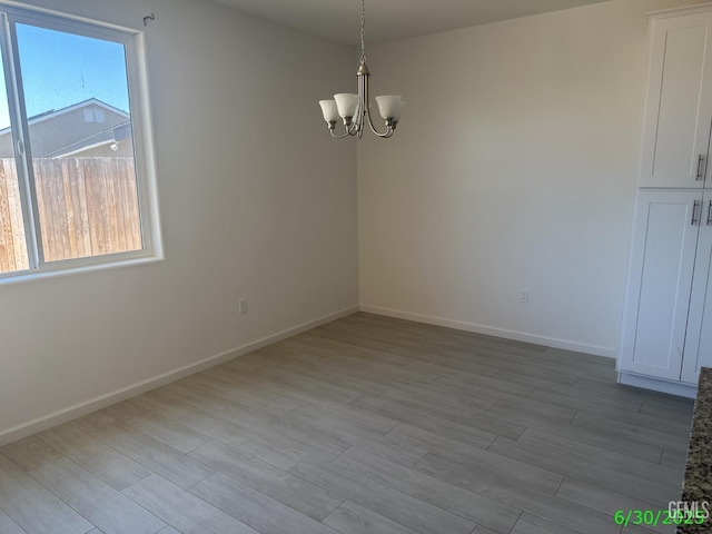 716 Montejo Ct, Delano, CA 93215 - empty room with a chandelier and wood finished floors