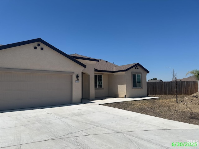 716 Montejo Ct, Delano, CA 93215 - ranch-style house featuring stucco siding, an attached garage, and driveway