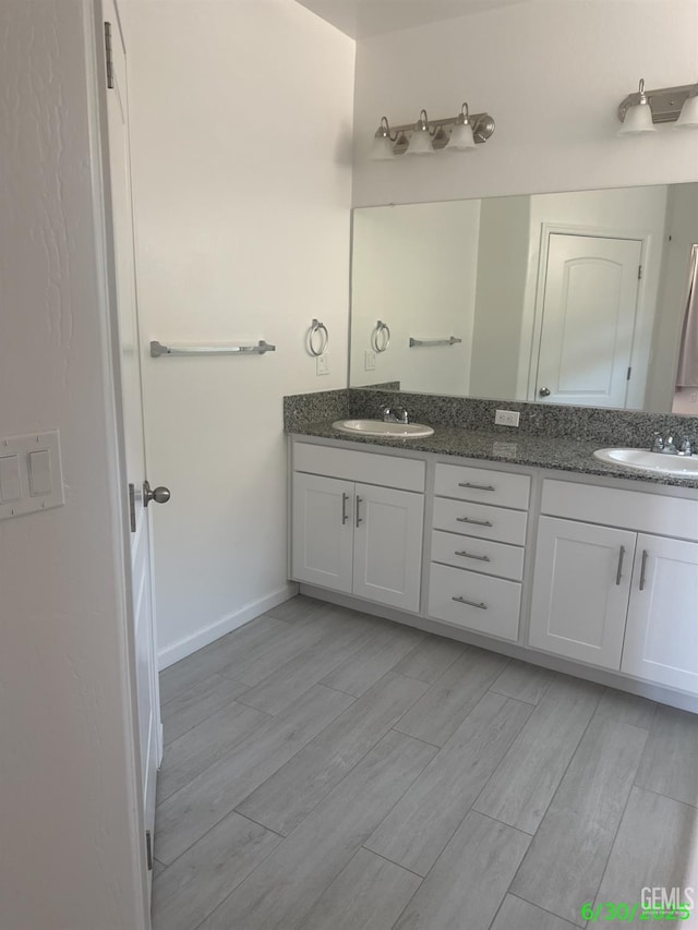 716 Montejo Ct, Delano, CA 93215 - bathroom with double vanity and wood finished floors