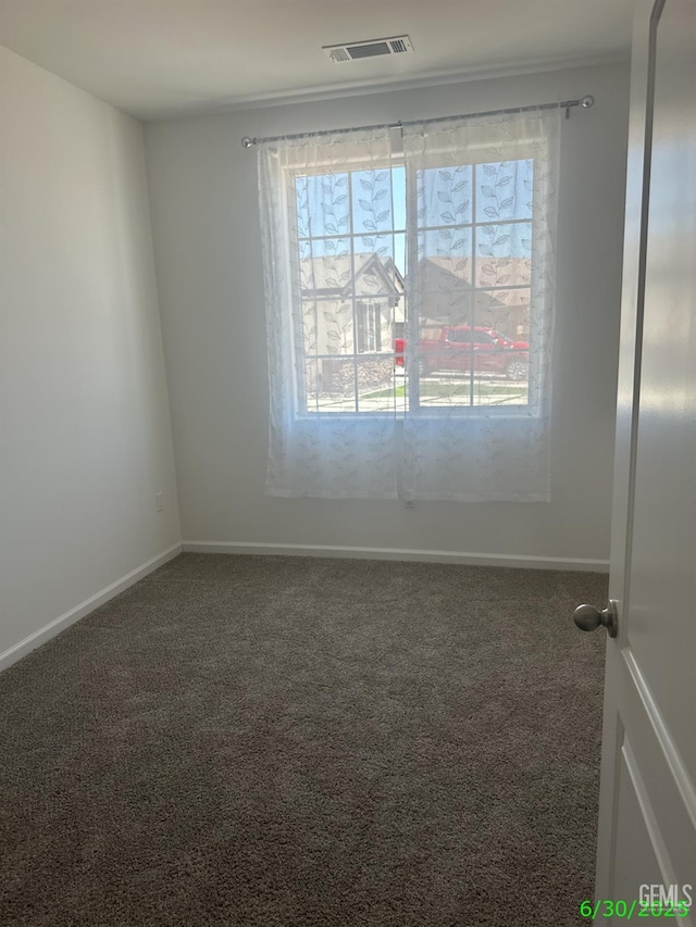 716 Montejo Ct, Delano, CA 93215 - empty room featuring carpet floors and plenty of natural light