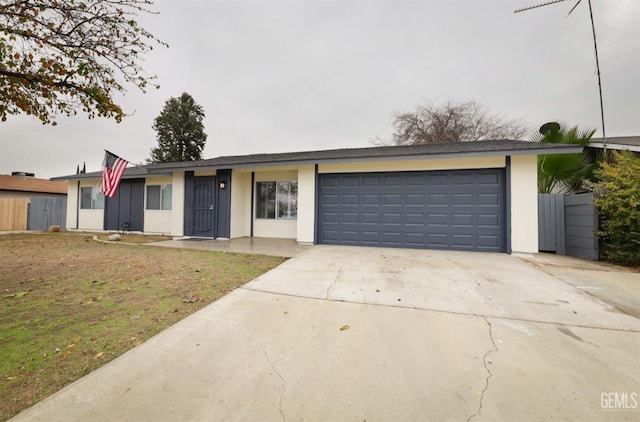 ranch-style house with a front yard and a garage