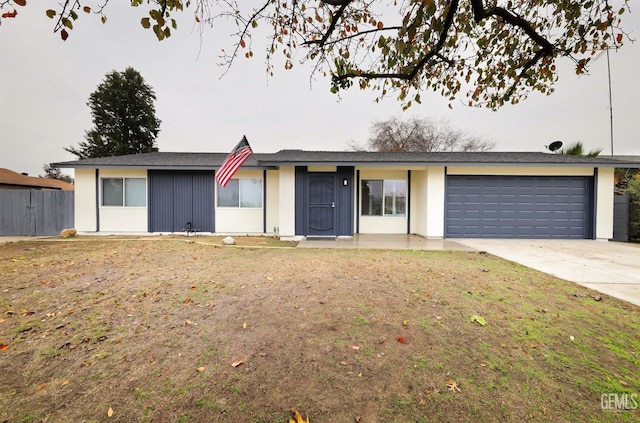 single story home with a garage and a front yard