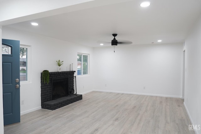 unfurnished living room with recessed lighting, a brick fireplace, light wood-type flooring, and a ceiling fan