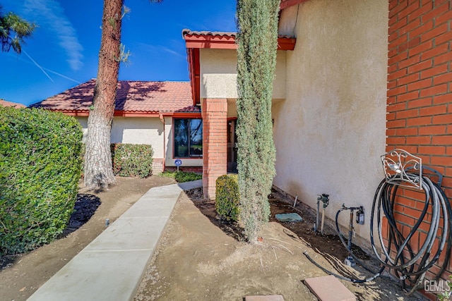 view of property exterior featuring stucco siding and a tiled roof