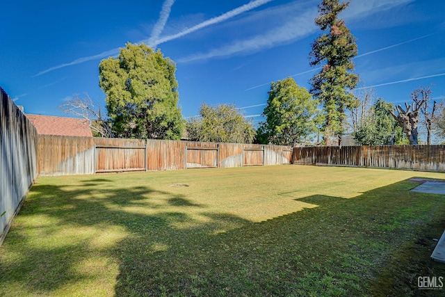 view of yard with a fenced backyard