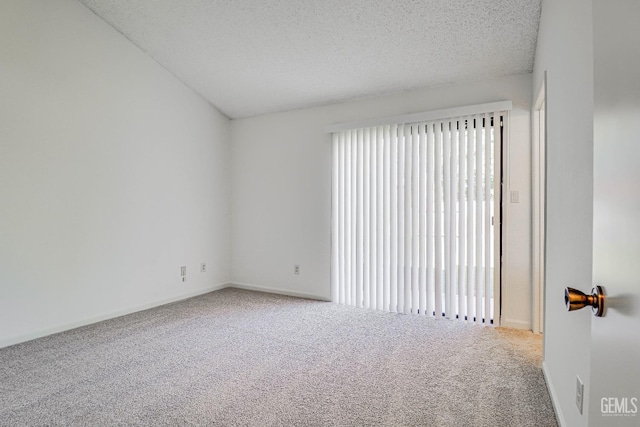 unfurnished room with carpet, a textured ceiling, baseboards, and a wealth of natural light