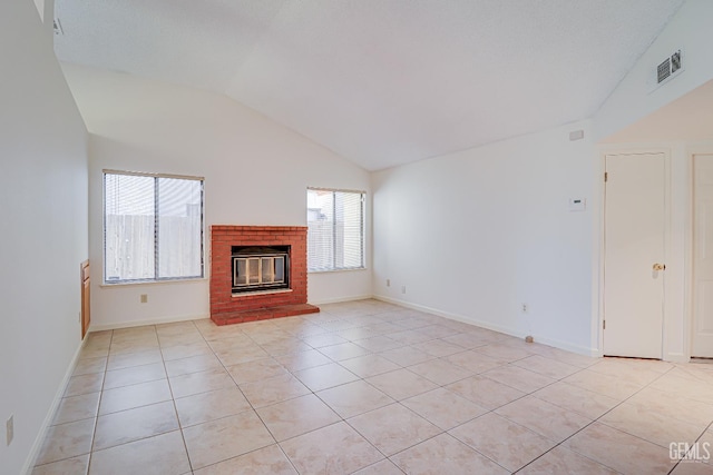 unfurnished living room featuring light tile patterned floors, visible vents, a brick fireplace, vaulted ceiling, and baseboards