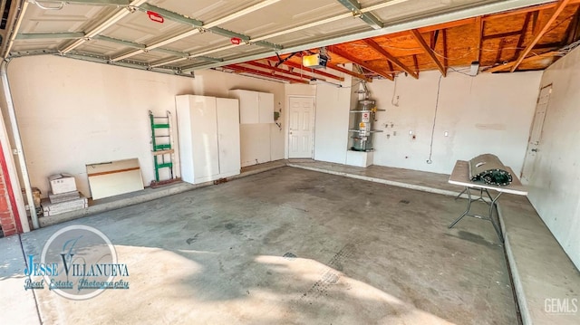 garage featuring water heater and a garage door opener