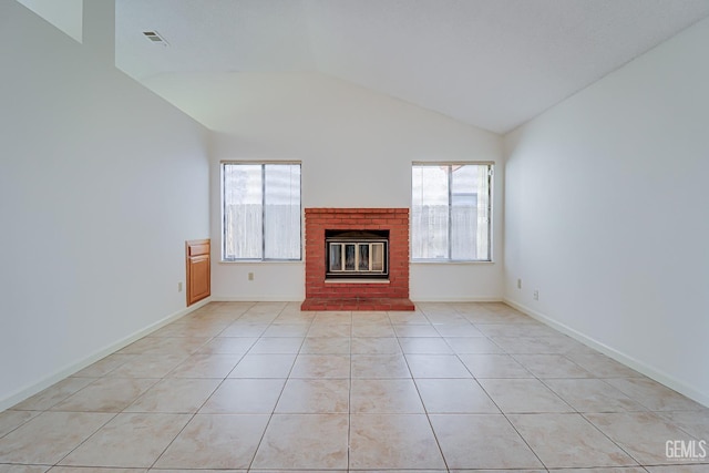 unfurnished living room with light tile patterned floors, a fireplace, visible vents, baseboards, and vaulted ceiling