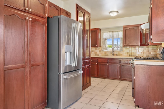 10801 Santa Clara St, Lamont, CA 93241 - kitchen with appliances with stainless steel finishes, decorative backsplash, light countertops, light tile patterned floors, and a sink