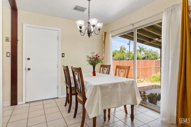 10801 Santa Clara St, Lamont, CA 93241 - dining space featuring a chandelier, light tile patterned flooring, and baseboards