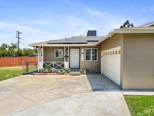 10801 Santa Clara St, Lamont, CA 93241 - single story home with stucco siding, concrete driveway, an attached garage, and solar panels