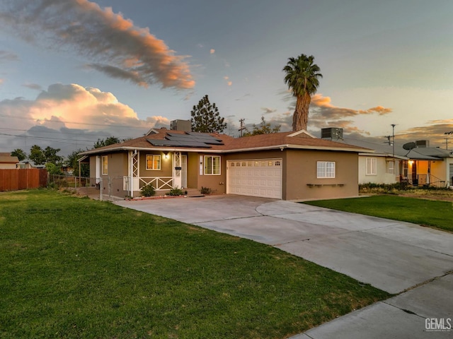 10801 Santa Clara St, Lamont, CA 93241 - ranch-style house featuring a porch, a garage, solar panels, stucco siding, and concrete driveway
