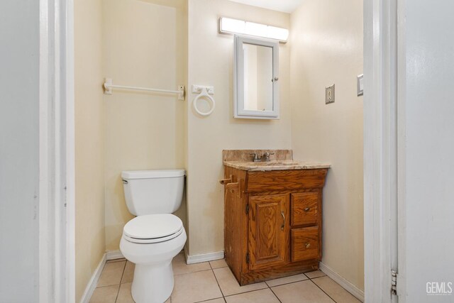 10801 Santa Clara St, Lamont, CA 93241 - bathroom featuring toilet, vanity, tile patterned floors, and baseboards