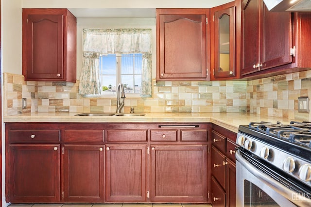 10801 Santa Clara St, Lamont, CA 93241 - kitchen featuring dark brown cabinets, a sink, light countertops, and stainless steel gas range