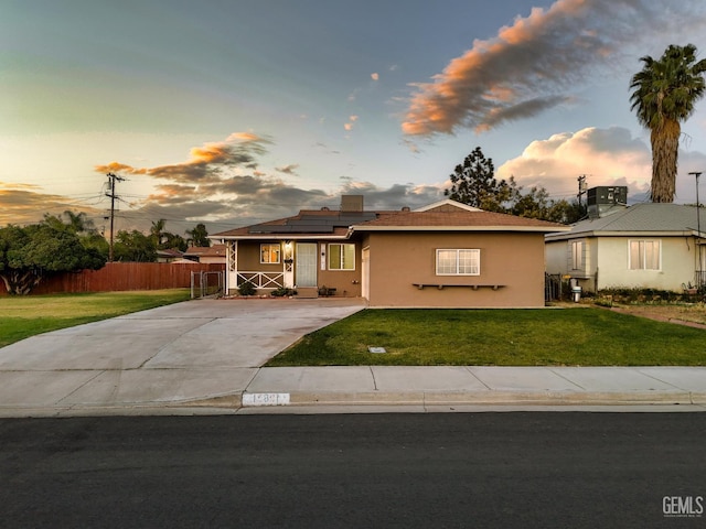 10801 Santa Clara St, Lamont, CA 93241 - view of front of property featuring roof mounted solar panels, stucco siding, and driveway