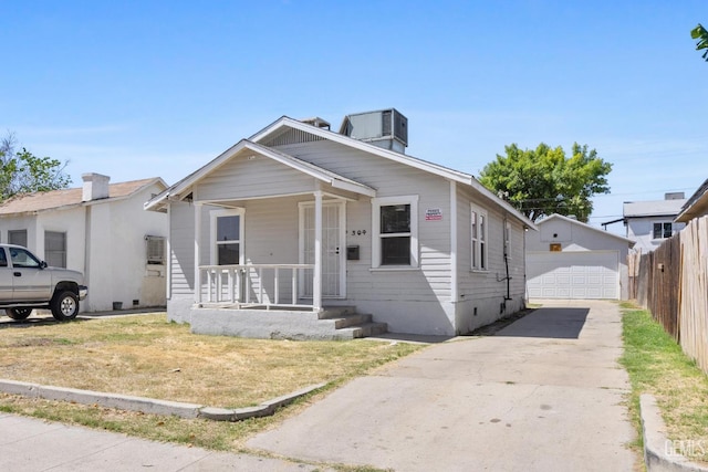 304 Wilson Ave, Bakersfield, CA 93308 - view of front of home featuring a porch, a garage, an outdoor structure, and central air condition unit