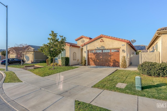 mediterranean / spanish-style home with a front lawn and a garage