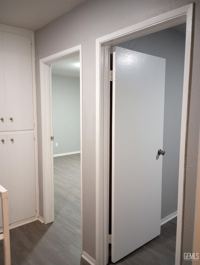 corridor featuring dark hardwood / wood-style flooring