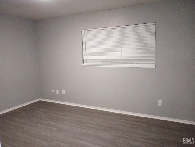 spare room with dark hardwood / wood-style flooring