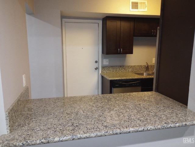 kitchen featuring light stone counters, stainless steel dishwasher, sink, and dark brown cabinets