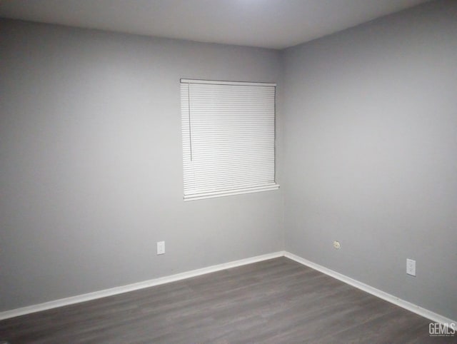 spare room with dark hardwood / wood-style flooring