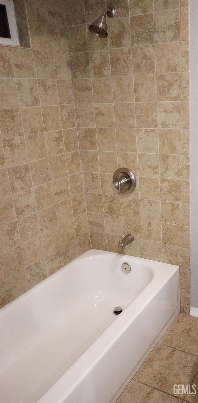 bathroom featuring tiled shower / bath and tile patterned flooring