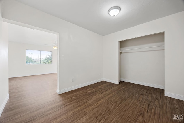 unfurnished bedroom featuring a closet, baseboards, and wood finished floors