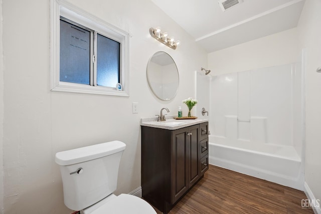 full bathroom with toilet, wood finished floors, vanity, visible vents, and tub / shower combination