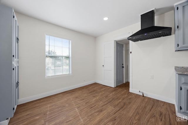 interior space featuring baseboards, wood finished floors, and recessed lighting