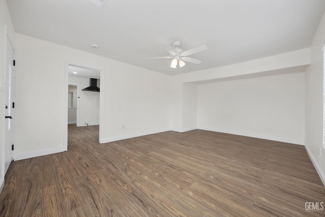 spare room with baseboards, a ceiling fan, and wood finished floors