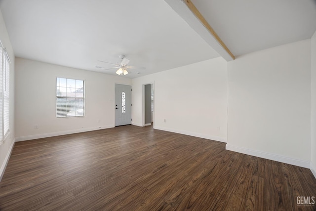 spare room featuring baseboards, dark wood finished floors, and a ceiling fan