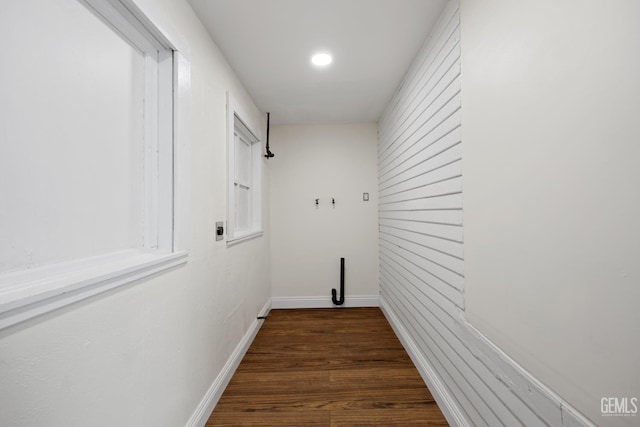 laundry room with laundry area, baseboards, dark wood-style flooring, and electric dryer hookup