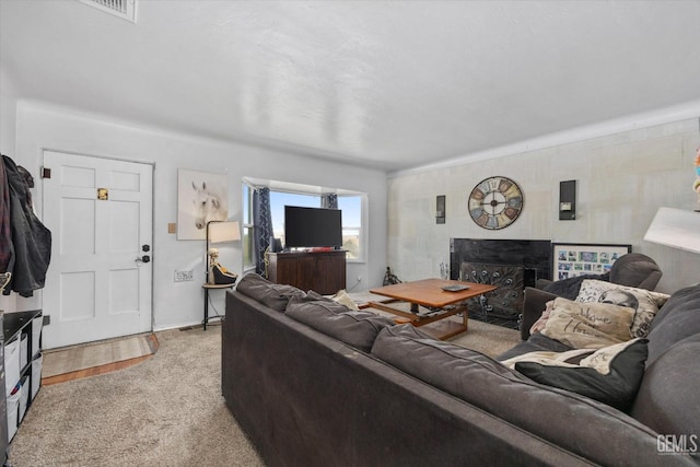 living room featuring light colored carpet and a fireplace