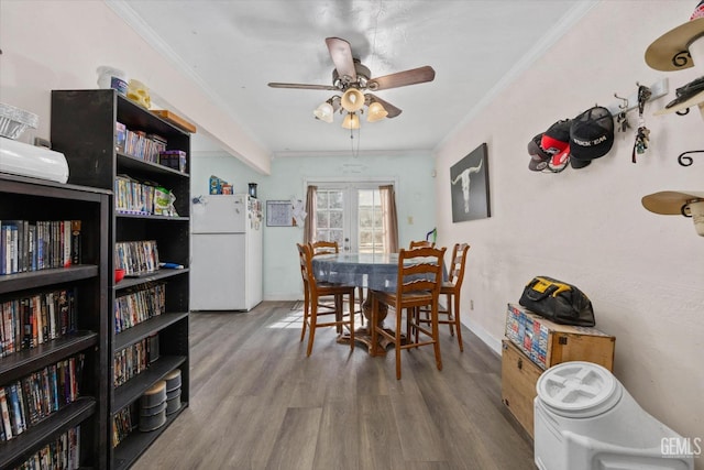 dining room with ceiling fan, french doors, ornamental molding, and hardwood / wood-style flooring